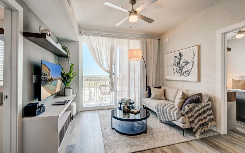 a living room with a fan and a couch