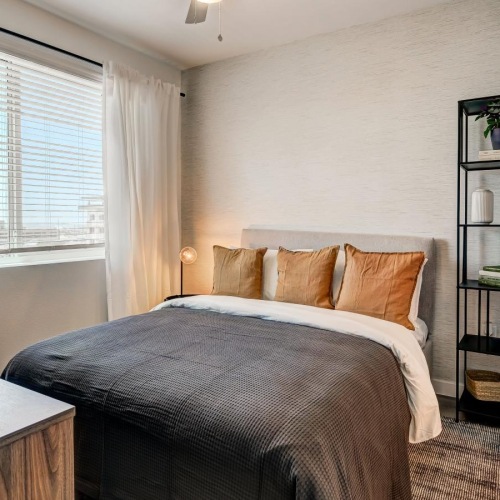 a bedroom with a bed and a fan