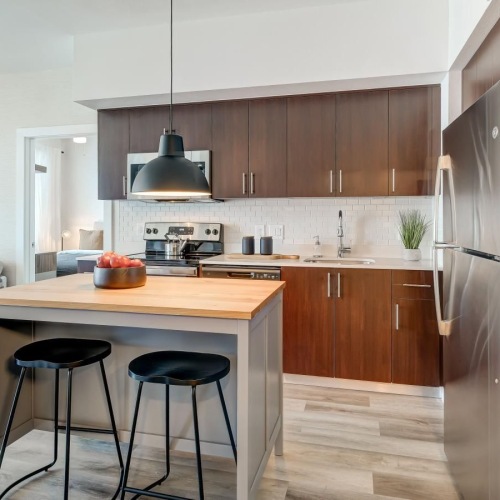 a kitchen with a table and stools