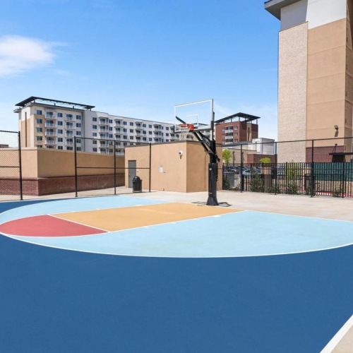 a large blue and red basketball court in front of a building