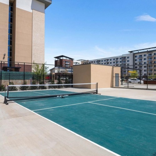 a tennis court in front of a building